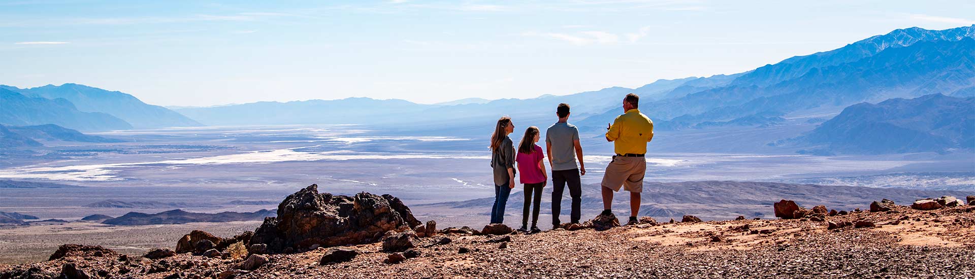  Pink Adventure Tour guide and guests viewing the Death Valley landscape from the Hell's Gate viewpoint.