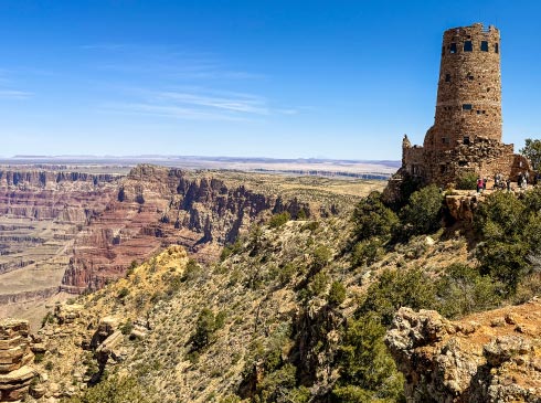 The Desert View Watchtower, one of the most iconic structures along the South Rim, perches on the edge of the vast Grand Canyon.