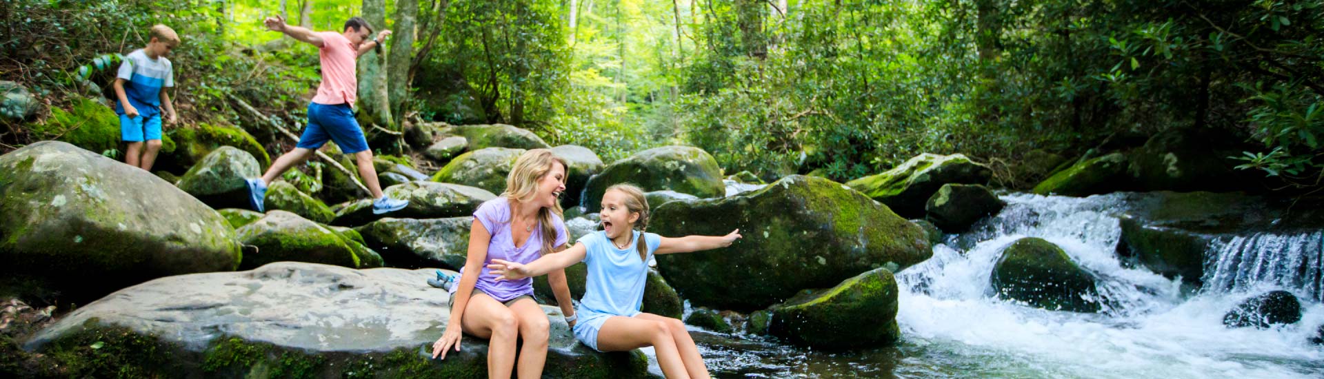 Family playing in creek along Roaring Fork Motor Nature trail, Great Smoky Mountains National Park