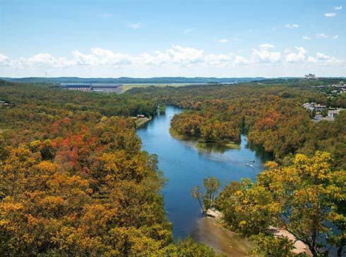 View of Lake Taneycomo from the 165 Scenic Overlook with fall foliage emerging, Pink Jeep Tours' Best of Branson Tour.