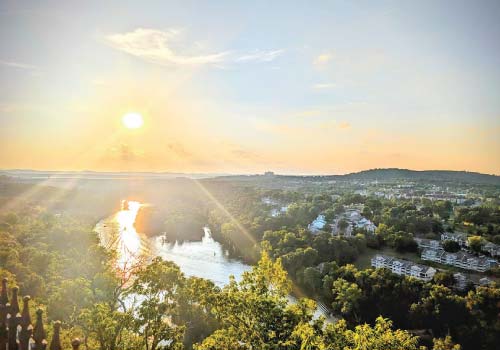 The setting sun is seen from an overlook above Lake Taneycomo in Branson, MO