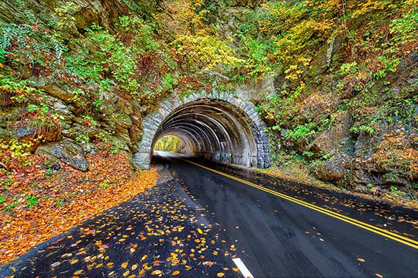 A landmark Smoky Mountains tunnel, which lies between Townsend, Tennessee and Cades Cove, is surrounded by a show of Autumn colors.