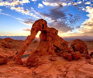 Crimson Aztec sandstone view of Elephant Rock against blue-violet sunset, Valley of Fire State Park near Las Vegas, NV.