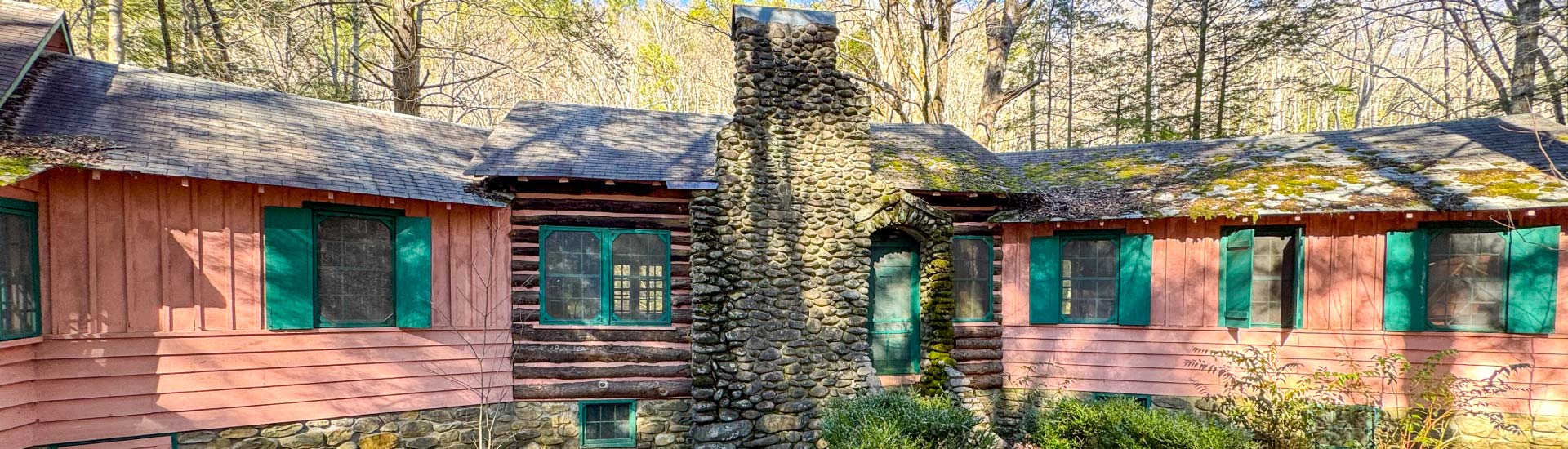 The Spence Cabin River Lodge in the Elkmont Historic District sits among dense trees in Great Smoky Mountains National Park, TN.