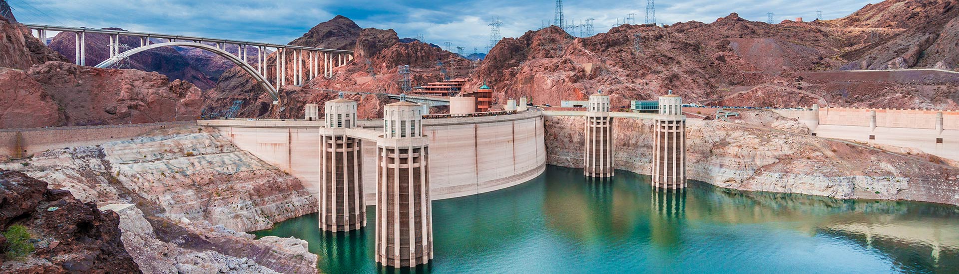 Beautiful image of the water intake towers and Mike O'Callaghan-Pat Tillman Memorial Bridge at Hoover Dam, with turquoise water in the foreground.