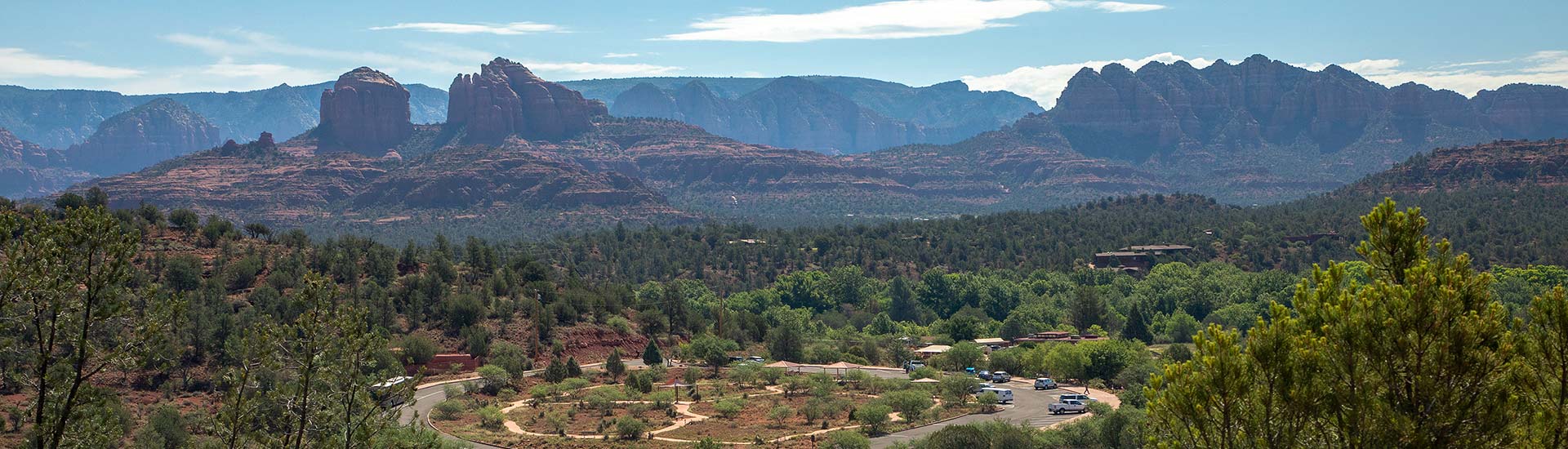 Aerial panorama of Red Rock State Park with views of Cathedral Rock, Courthouse Butte and other Sedona rock formations in the distance.