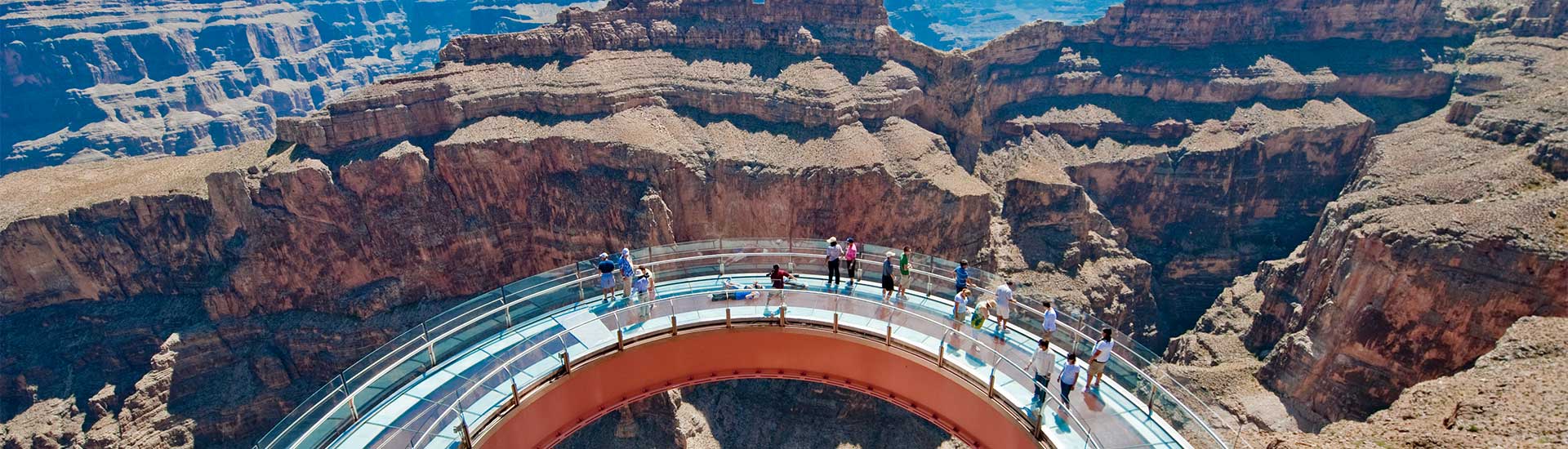 Aerial view of tourists standing on the curved platform of the Grand Canyon Skywalk overlooking the Grand Canyon West Rim, AZ.