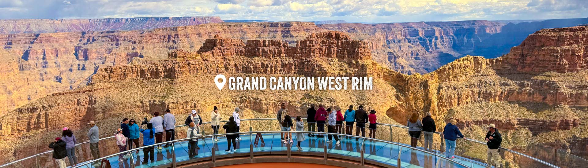 Grand Canyon West Rim visitors stand on the Skybridge overlooking the Canyon. Text across the image identifies the location as "Grand Canyon West Rim."