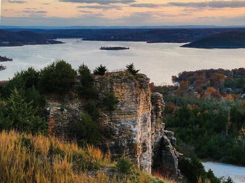 View of Table Rock Lake at sunset surrounded by fall-colored forests, Branson, Missouri.