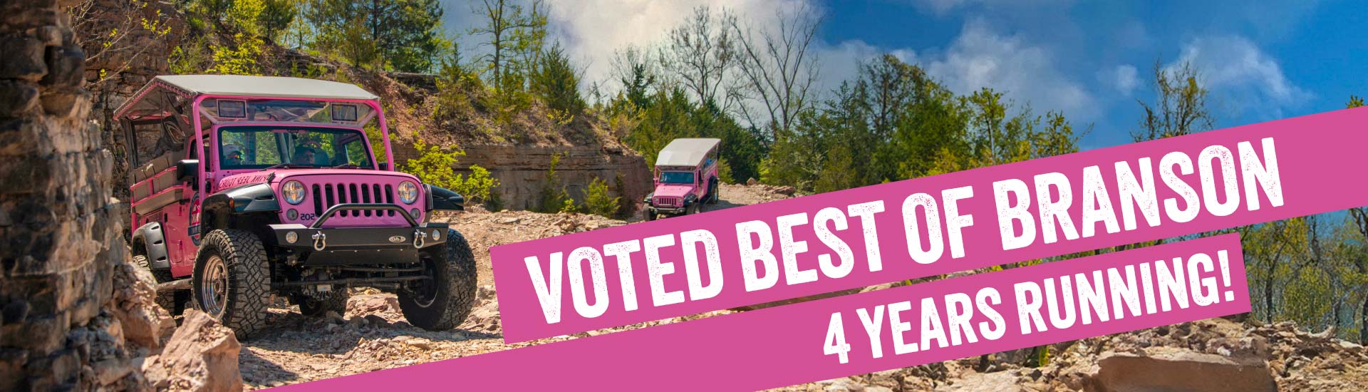 A pink jeep wrangler on a rocky trail on Baird Mountain in Branson, MO. A pink banner reads: Voted best of Branson 4 years running!