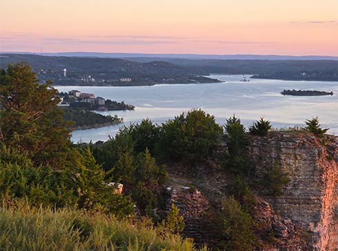 View of Table Rock Lake from Baird Mountain lookout during a soft pink sunset, Pink Jeep Tours Best of Branson Tour.