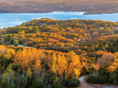 erial view from Pink Jeep Tours Branson’s private mountain of Table Rock Lake, surrounded by an Autumn colored forest.