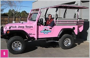 Auto-shop worker seated in a finished, custom outfitted Pink® Jeep® Tours Wrangler.