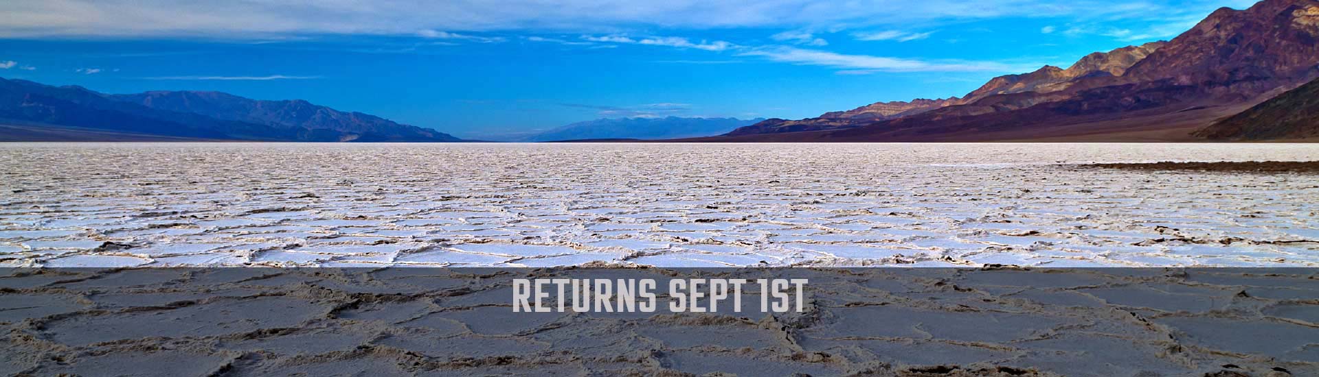 Death Valley National Park  image of white salt flats with Pink Jeep Tours Returns Sept 1st banner.