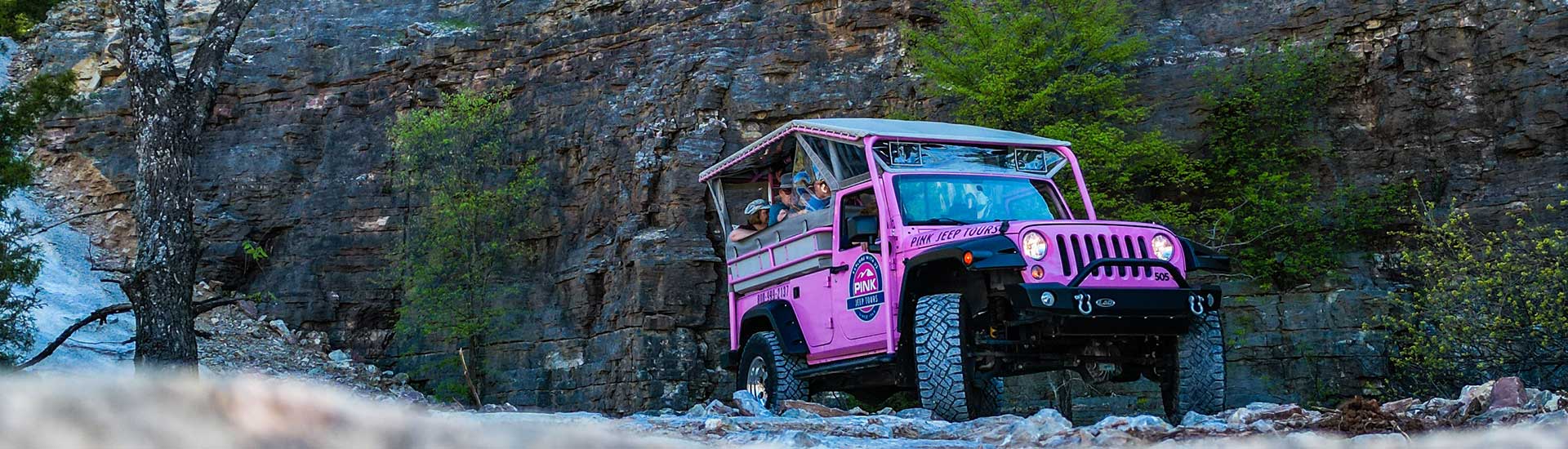 Pink Jeep Tours Branson Pink Jeep Wrangler driving through the rock quarry below Baird Mountain, Branson, MO.